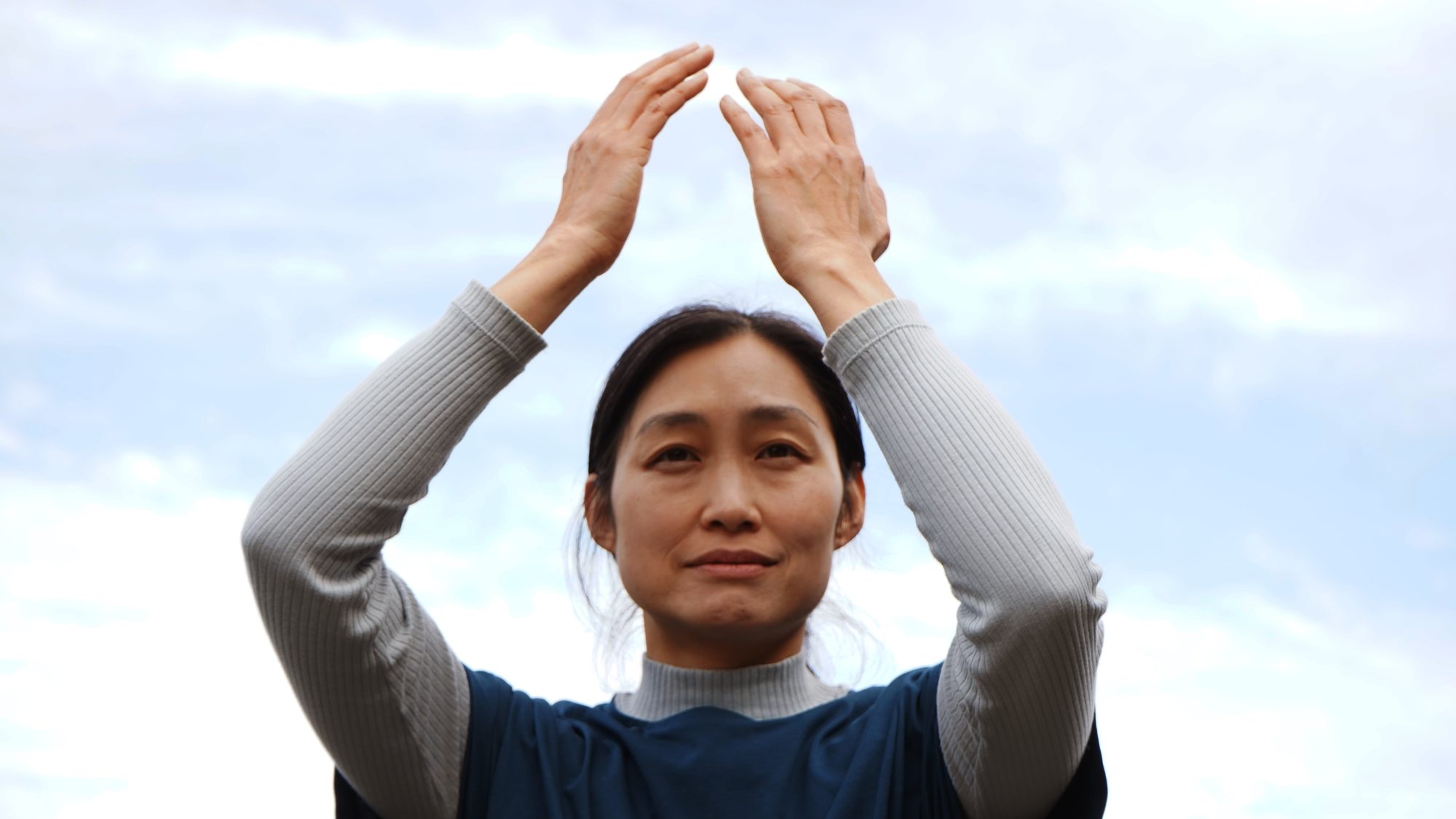 Serok Park practicando Qigong con los brazos hacia el cielo